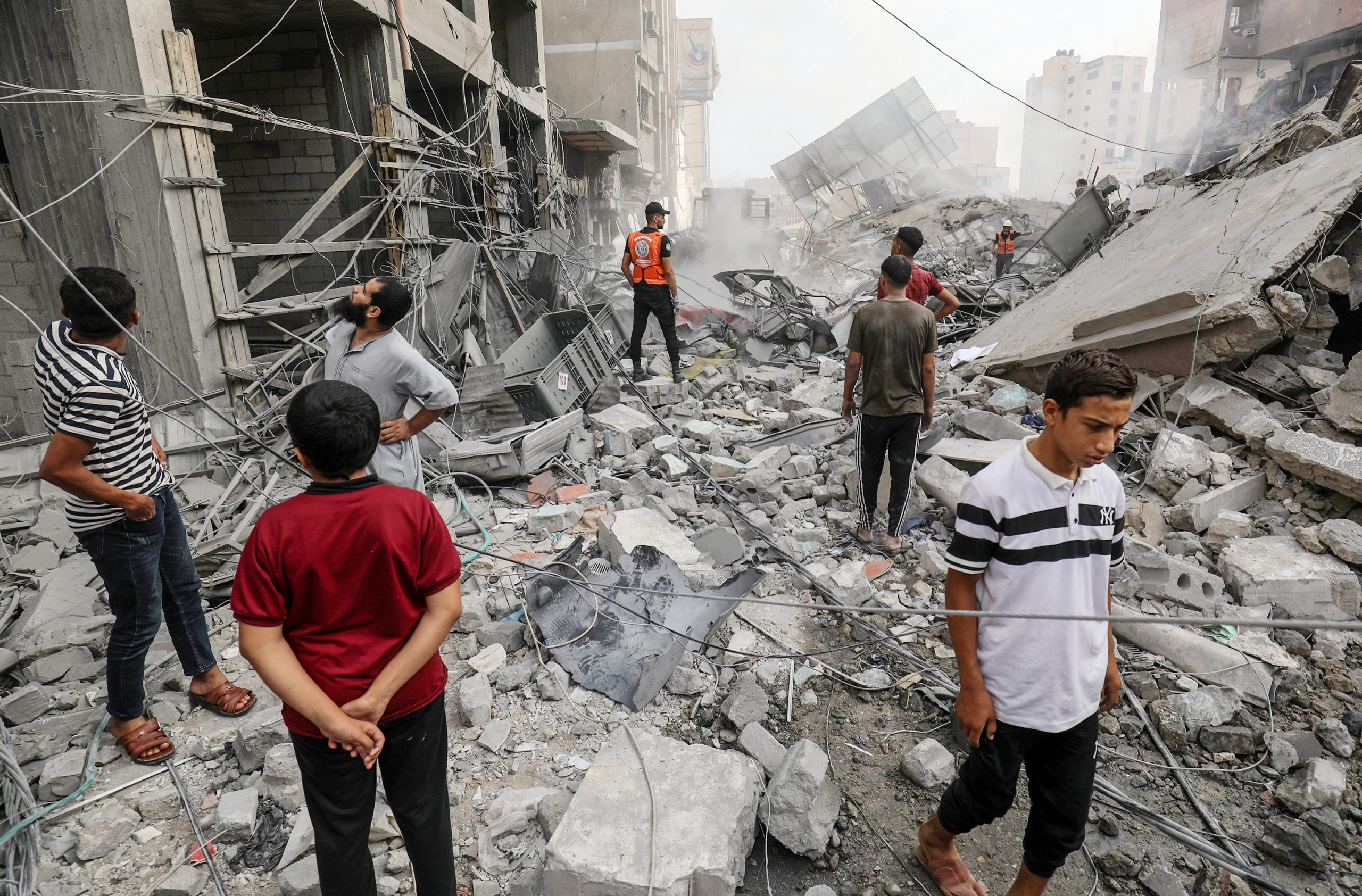 فلسطينيون من مدينة خان يونس يتفقدون مباني مدمرة نتيجة القصف الاسرائيلي