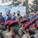 أحمد الشرع يتابع عرضاً عسكرياً خلال الاحتفال بذكرى سقوط نظام الأسد (أ ف ب)