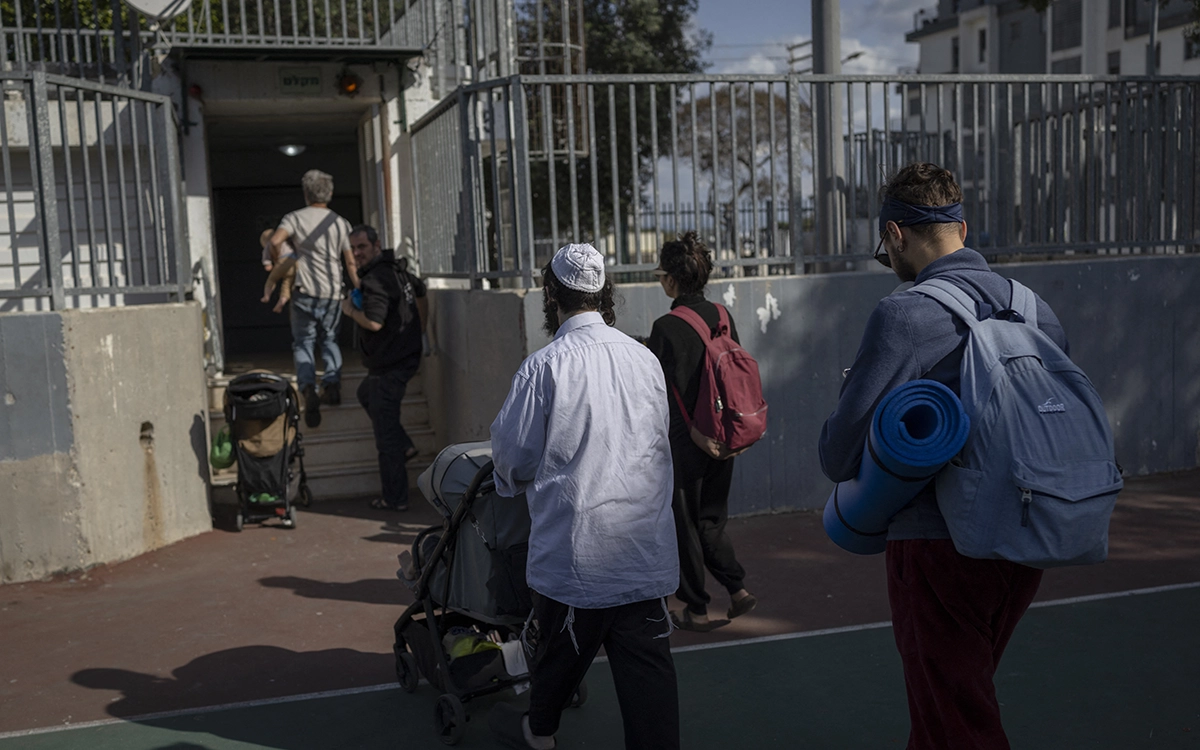 إسرائليون يتجهون نحو أحد الملاجئ بعد دوي صفارات الإنذار في تل أبيب (أ ف ب)