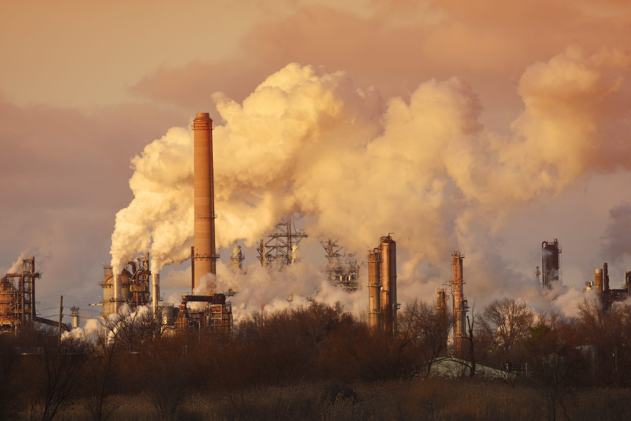Air pollution from smoke stacks at oil refinery