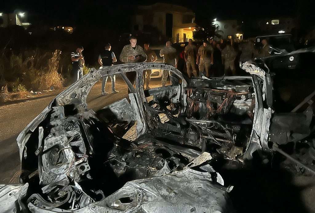 Lebanese army soldiers inspect the wreckage of a car targeted by an Israeli drone attack in the southern Lebanese village of Babliyeh. AFP