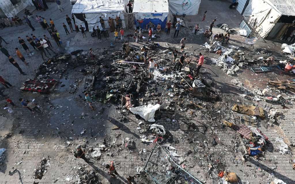 Palestinians inspect the damage caused by an Israeli airstrike that targeted a school sheltering displaced people. AFP