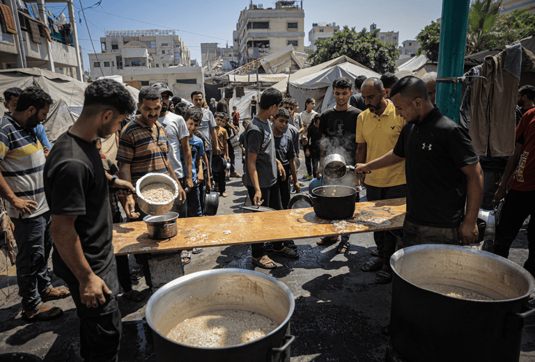 Palestinians waiting in line for food rations. AFP