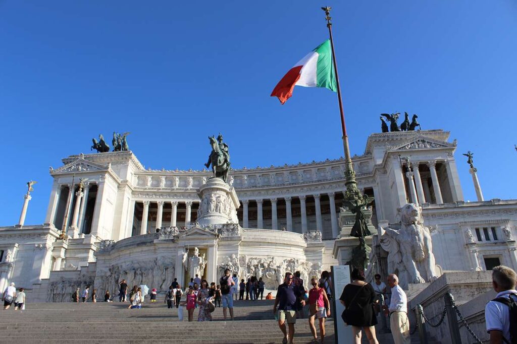 Italians walk past a memorial in central Rome.