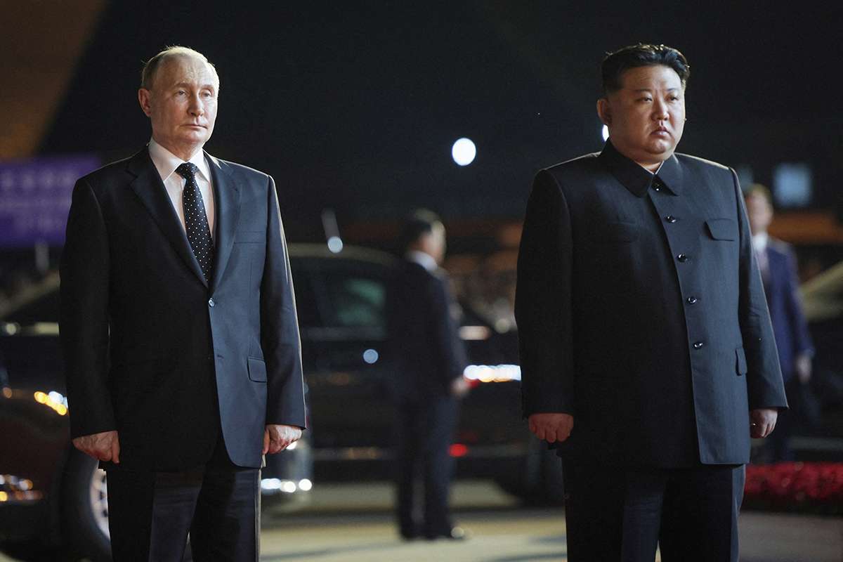 Russian President Vladimir Putin stands beside North Korea's leader Kim Jong Un.