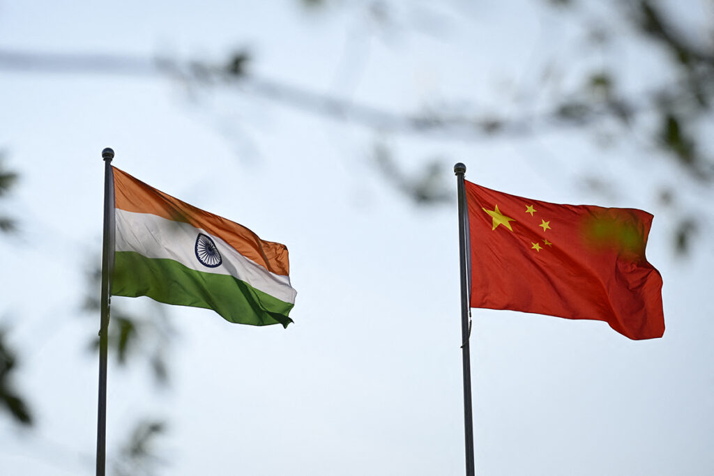 The national flags of India (L) and China are seen outside the Meijiang Meijiang Convention and Exhibition Center during the Shanghai Cooperation Organisation (SCO) Summit in Tianjin on August 31, 2025. (Photo by WANG Zhao / AFP)