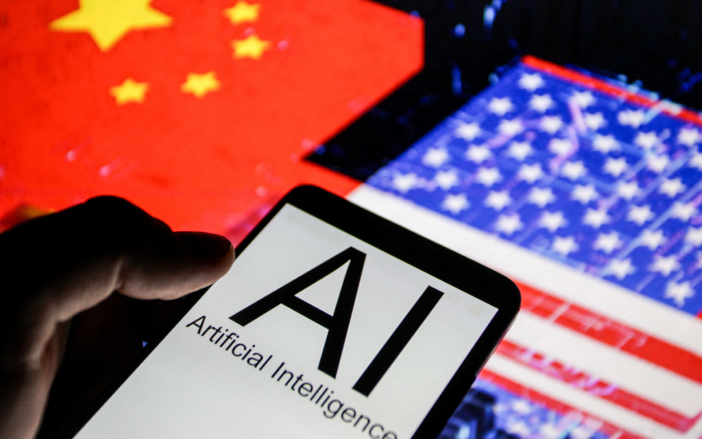 Close up view of a smartphone displaying the words AI Artificial Intelligence in front of blurred flags of the United States and China