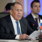 Russian Foreign Minister Sergey Lavrov speaking at the summit in Manila, Philippines, with a Russian flag on his desk.