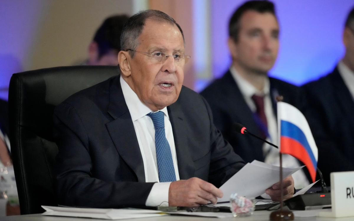 Russian Foreign Minister Sergey Lavrov speaking at the summit in Manila, Philippines, with a Russian flag on his desk.