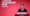 Andy Burnham giving a speech at a desk in front of a red background which reads "Labour Leadership 2026"