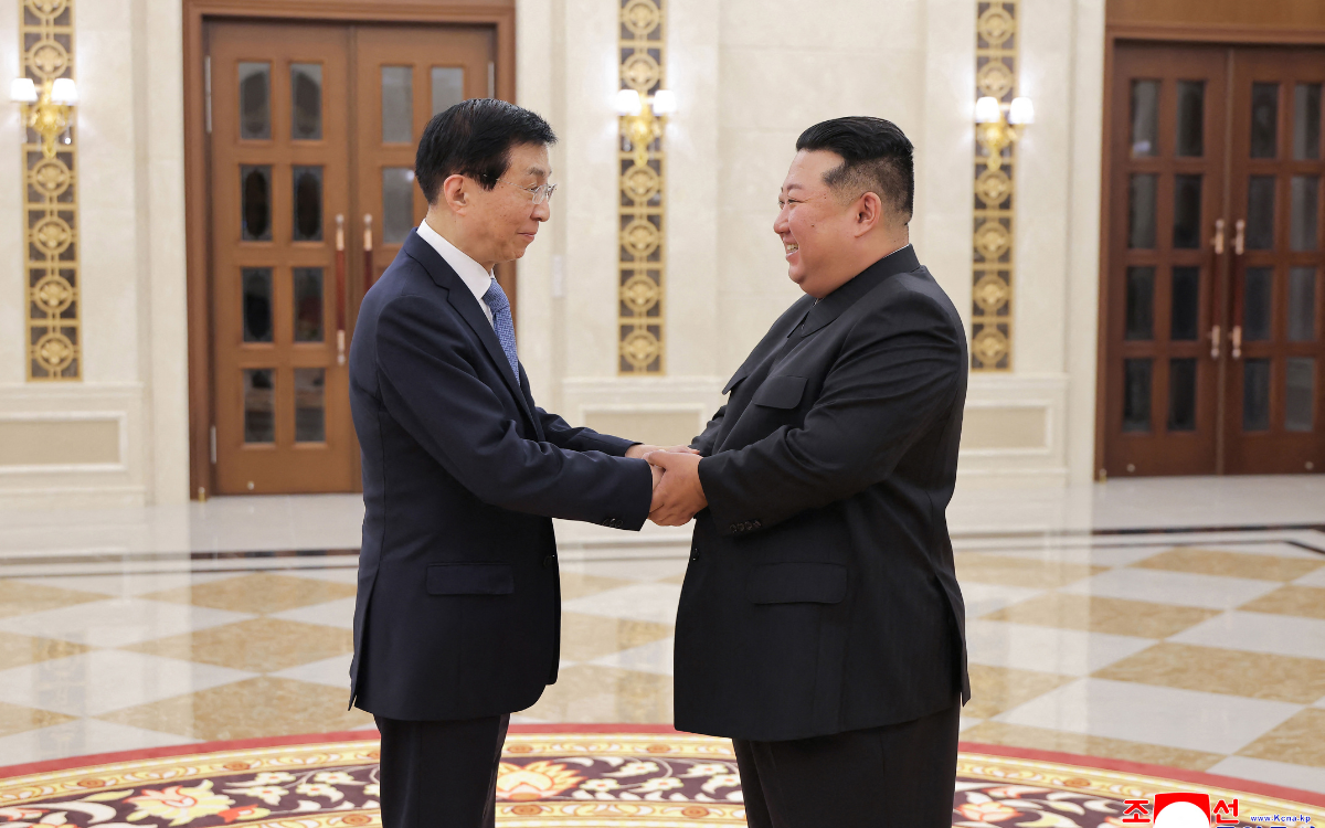 North Korean leader Kim Jong Un shakes hands with top China official Wang Huning