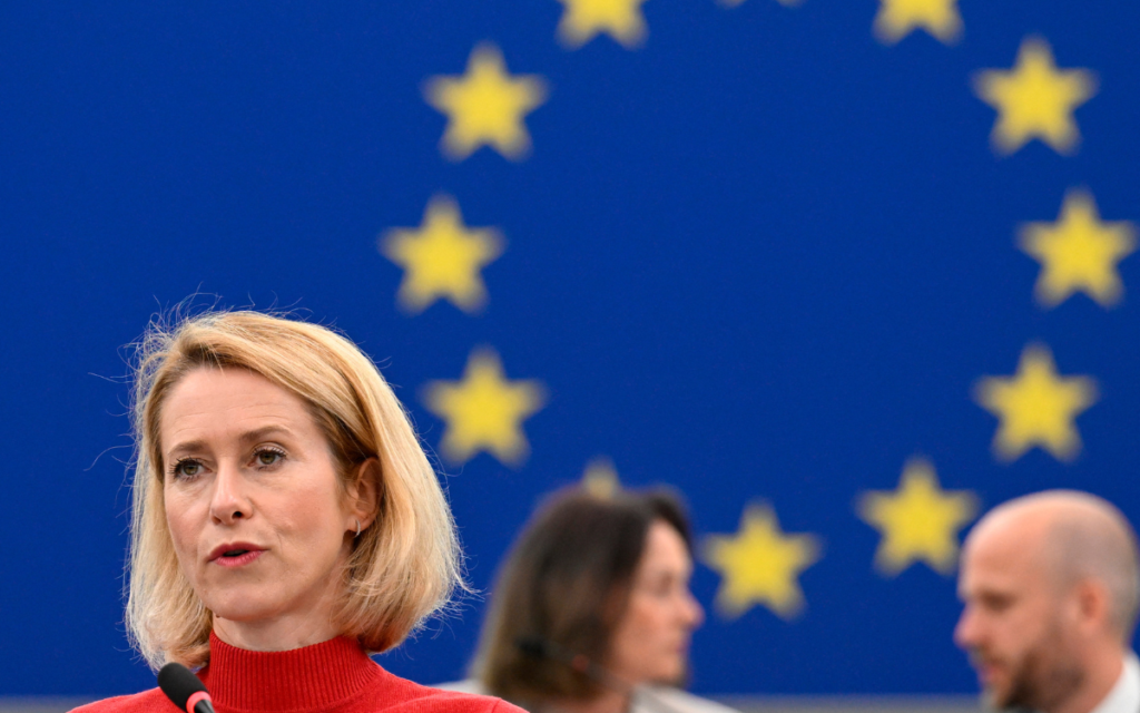 Top European Union diplomat Kaja Kallas speaking with the EU flag behind her